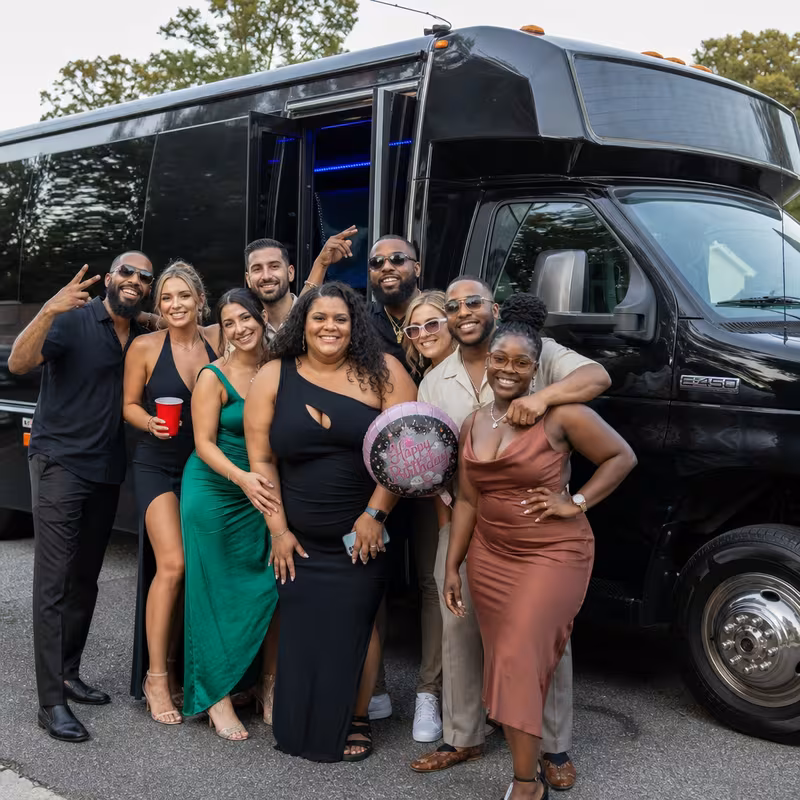 Group boarding a white charter bus for Birthday Transportation transportation in Stockton