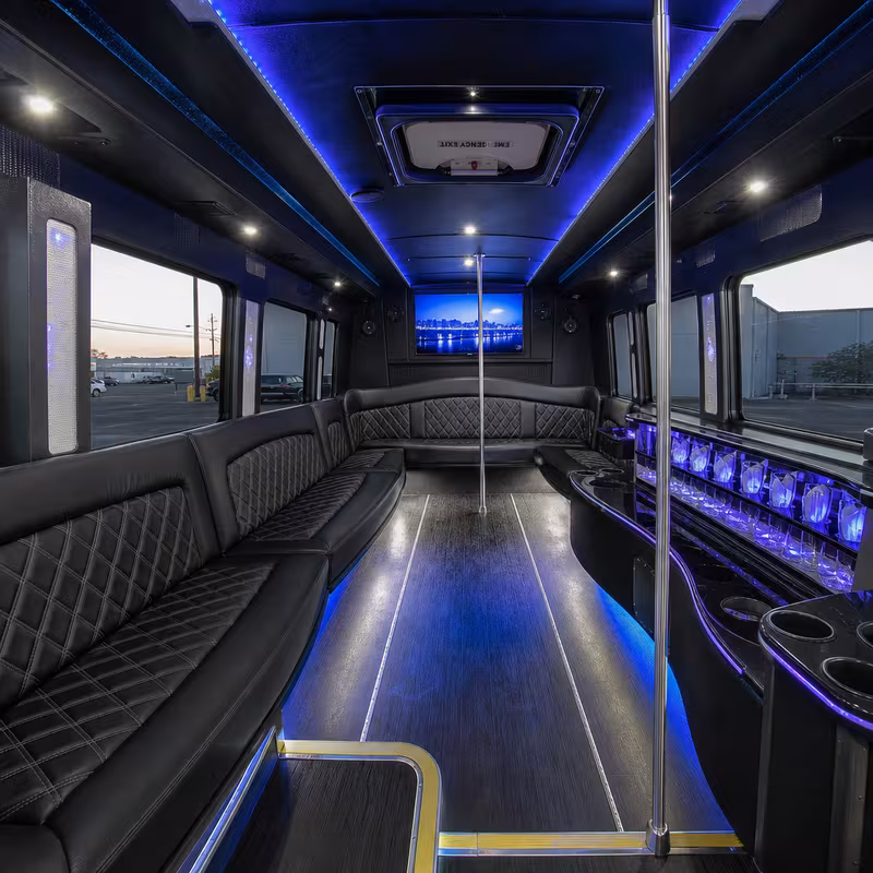 Party bus interior with wraparound leather seating and LED lighting in Stockton