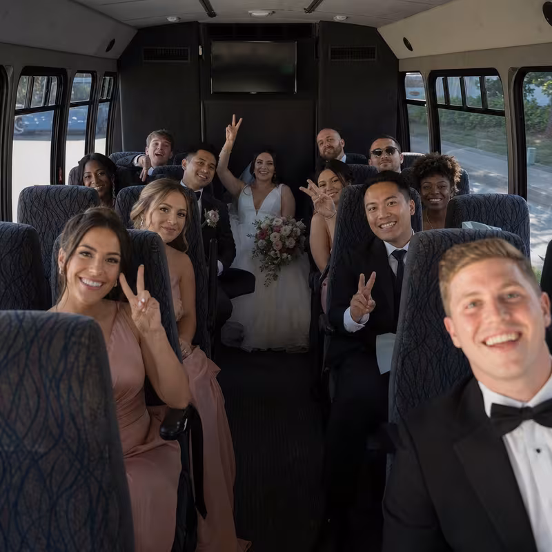 Group boarding a white charter bus for Wedding Transportation transportation in Stockton