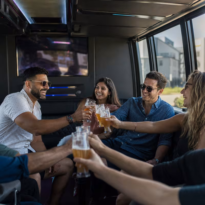 Group boarding a white charter bus for Winery & Brewery Tour Transportation transportation in Stockton