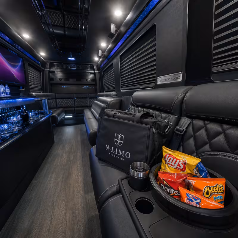 Party bus interior with wraparound leather seating and LED lighting in Stockton